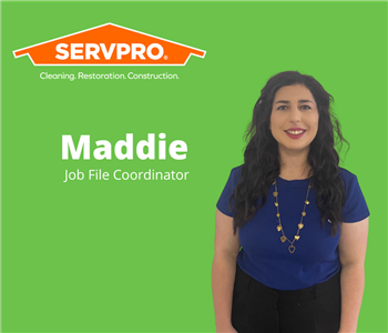 female employee standing in front of green background with servpro logo